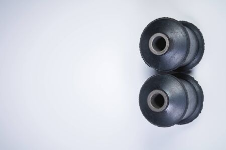 Classic silent blocks car suspension kit one pair on a gray background. Rubber parts with metal bushingsの写真素材