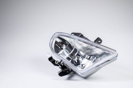 New spare parts for the car. Recessed fog lamp on a gray background.