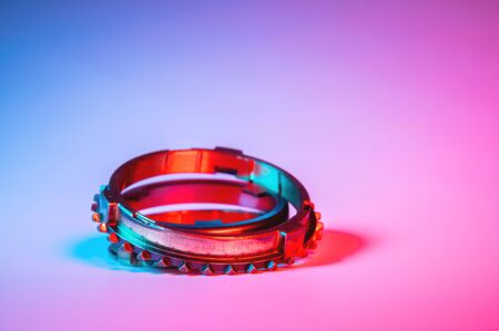 The individual elements of the transmission gear in the gearbox. A new set of synchronizers in brass in blue and red.の写真素材