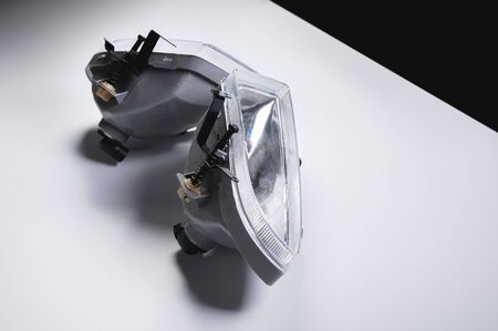 A pair of new fog headlights for front light spare parts on a grey gradient backgroundの写真素材