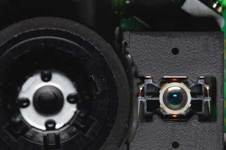 Macro close-up of a DVD drive head with a laser lens on the background of microcircuits. Electronics backgroundの写真素材