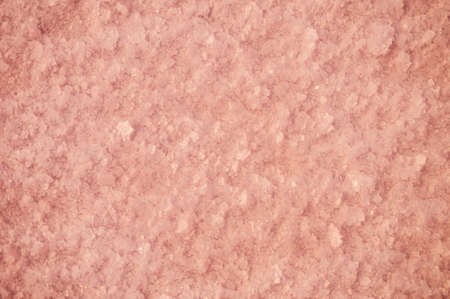 Crystals of pink salt at the bottom of the lake through pink water. Salt background in defocusの写真素材