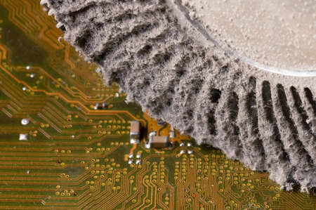 Dirty aluminum heatsink for cooling the central processing unit of a personal computer. Lumps of dust and dirt on the cooling element. Cause of electronics failureの写真素材