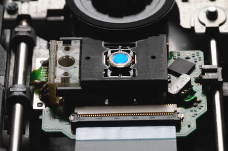 Closeup of a laser head and dvd rom drive with boards. Writing and reading with laser technologyの写真素材