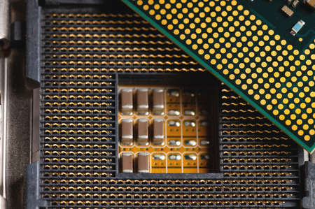 Blank cpu cpu socket with pins on motherboard in yellow color close-upの写真素材