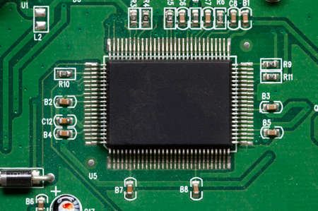Close-up of computer chip on green pc motherboard microchip
