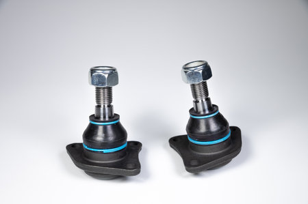 Two ball joint car suspension on a gray background. New spare parts axel car elementsの写真素材