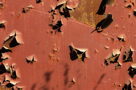 Vintage background large pieces of red paint fall off peeled off rusty metal surface