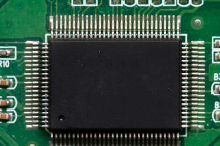 Close-up of computer chip on green pc motherboard microchip