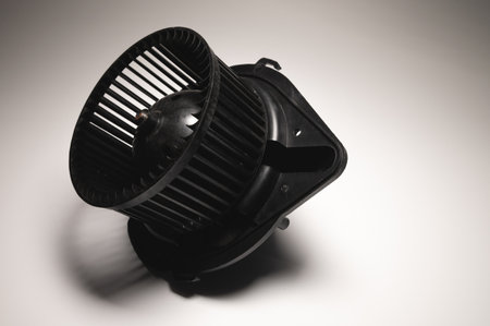 Heater motor. A spare part for an automobile heating system on a black-gray gradient background. Low...