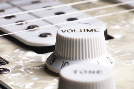 Close-up of electric guitar pickups and volume knobの写真素材