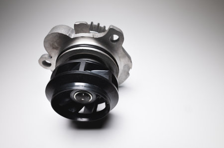 Car engine coolant water pump new on a gray background. Spare parts