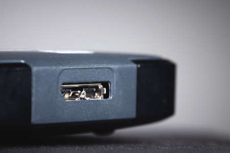 Gray external hard drive with usb 3.0 micro-b port. Close-up of the port