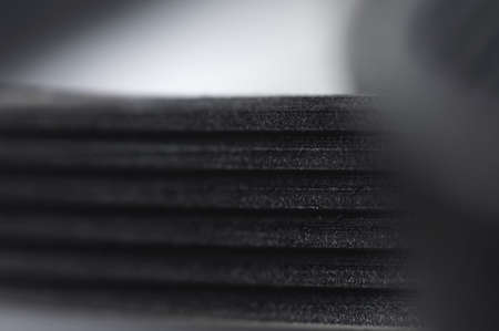 Close-up of a poly V-belt of a generator on a gray background in shallow depth of field. Background for rubber products of auto partsの写真素材