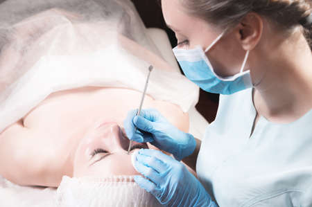 Close-up Professional face cleaning. Mechanical facial cleansing procedure. Peeling of the skin of...