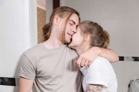Young caucasian family couple man and woman laughing hugging in bathroom