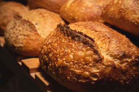 Freshly baked hot loaves of crispy artisan bread close-up. Healthy foods and proper nutrition