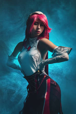 Gothic anime character rosary sexy killer woman with pink hair in black and white. In a sexy pose on a dark blue smoky backgroundの写真素材