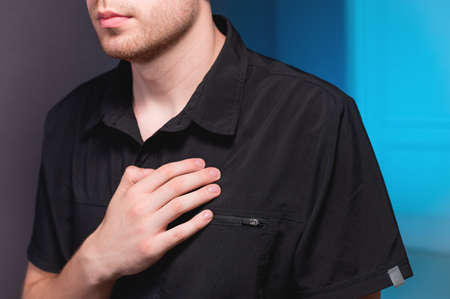 Self-massage of the pectoral muscles of a Caucasian male massage therapist for myofascial massage of...