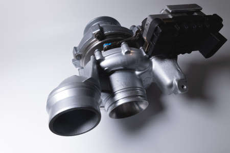 Spare part New car turbine on a white background. close-up. Car parts copy spaceの写真素材