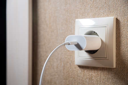 Close-up of a usb charging unit with a usb c connector and a white wire. European socket. The concept of providing electricity to the European Unionの写真素材