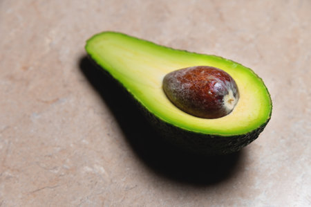 Close-up Fresh vegetables - Zutano avocado on a table with a black background. Contrasting image of a tasty vegetableの写真素材