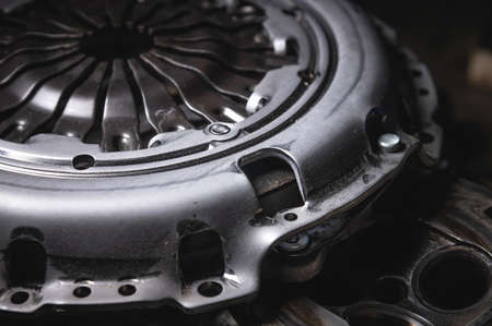 Close-up clutch disc of a car lies on metal parts contrast shotの写真素材
