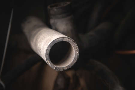 Rubber pipes and hoses leading from the car radiator to the engine, view of the engine from below....