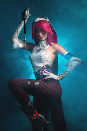 Young beautiful caucasian girl in sexy cosplay with pink hair and voluminous breasts