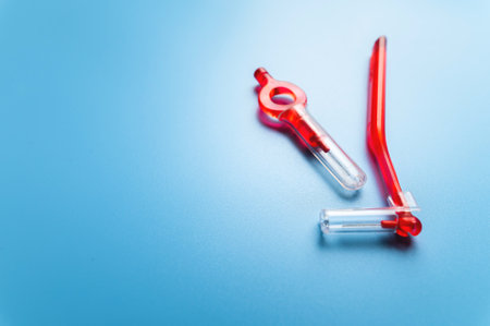 interdental orthodontic brushes for teeth of red color lie on a blue background with free space for...