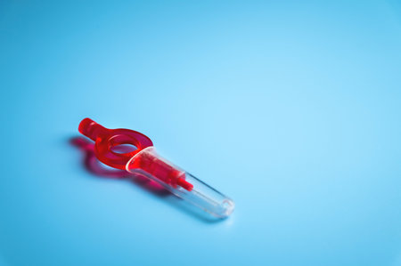 Toothbrush for dental braces of red color lies on a blue background