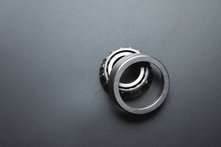 Two-piece tapered bearing. New spare part on a black backgroundの写真素材