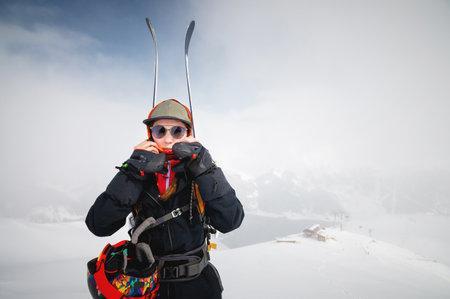 Mountaineer backcountry skiing skiing woman climber in the mountains. Ski tourism in the alpine landscape. Adventure winter sport. Freeride on skisの写真素材