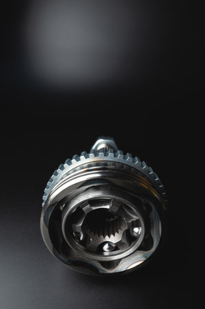 Auto CV joint Connecting the drive shaft on a black background. New hinges of equal angular speeds....