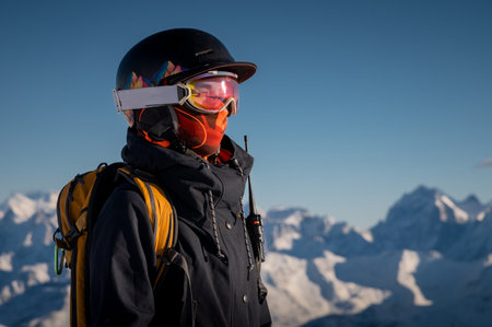 Profile of a female skier in ski goggles in the mountains. A woman in a sports ski jacket and...