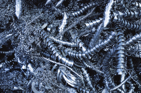 Steel scrap materials recycling. Aluminum chip waste after machining metal parts on a cnc lathe. Closeup twisted spiral steel shavings. Small roughness sharpness,の写真素材