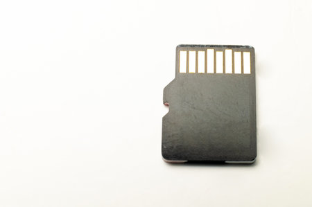 Micro SD memory card adapter on a white background. close-up, top view