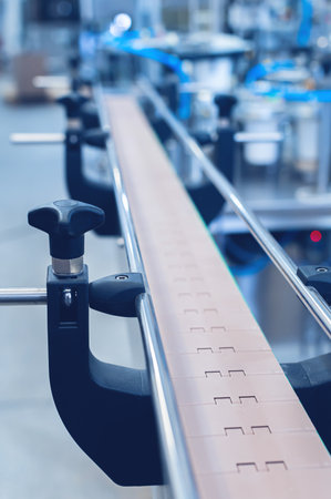 An empty production line conveyor belt at an equipment assembly plant. Toned image.