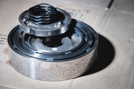 A close-up of a pack of clutches on a shaft with a gear from an automatic transfer case of a...