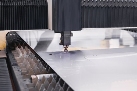 Scene close up, laser cutting machine cuts a metal plate. High-tech sheet metal production process...