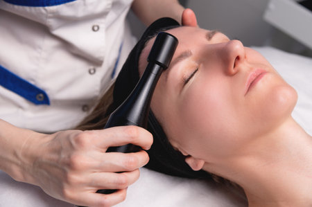Hardware facelift procedure. Hardware cosmetology. A beautiful woman having a lymphatic drainage...
