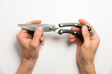 worker holds a pruner with black handles on a white background, close-up. garden toolsの写真素材