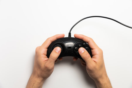 Male hands holding retro gamepad on white background. Flat top