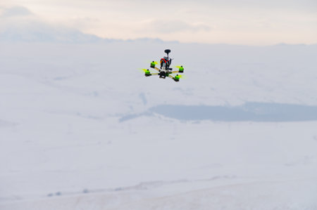 flying homemade drone with bright details on the body in abstract winter environment, close-up. hobby for adultsの写真素材