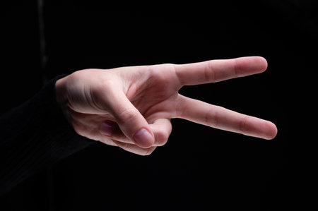 Woman's hand showing two fingers up. Peace, victory symbol, letter V in sign language or number two...