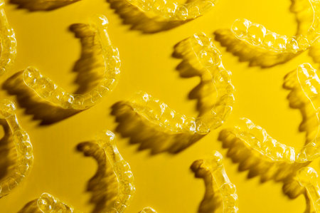 Orthodontic silicone aligner background. Advertisement of invisible braces retainer. Medical website...