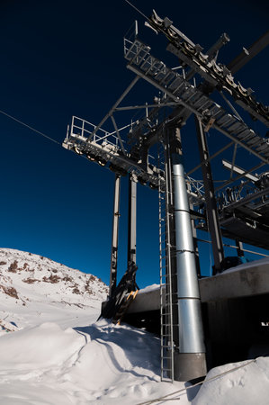 Cable car station. Wide angle view of monolithic cable car structure in snowy mountains in cloudless weatherの写真素材