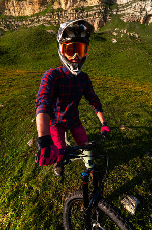 Vertical photo of young athlete view from above wide angle. Professional rider on mountain bikeの写真素材