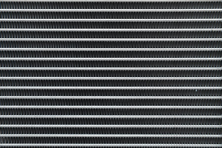 Close-up of the honeycomb texture of an aluminum car radiatorの写真素材