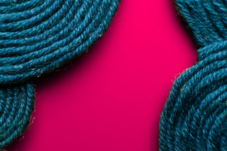 Textile background. Patterns of colored wool thread on a colored background with copy space for a...